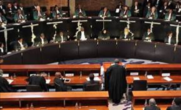 International Court of Justice in The Hague with multiple national flags symbolizing global legal alignment on Gaza case