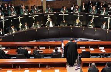 International Court of Justice in The Hague with multiple national flags symbolizing global legal alignment on Gaza case