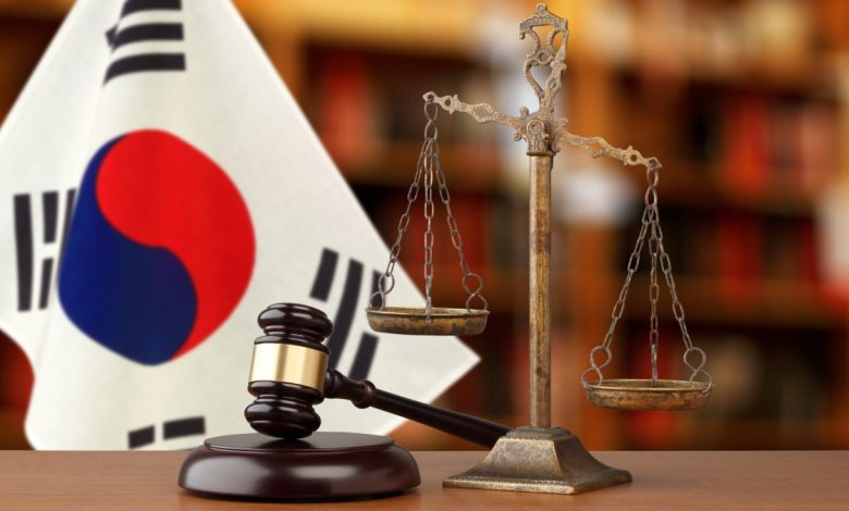 Person silenced with tape over mouth symbolizing censorship and free speech crisis