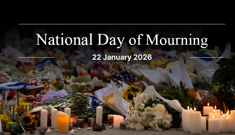 Memorial ceremony in Bondi with candles and flowers honoring victims of tragedy